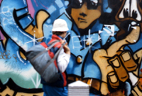 Steve kerr in front of 'devious' piece by 'The Chrome Angelz' Covent Garden 1985